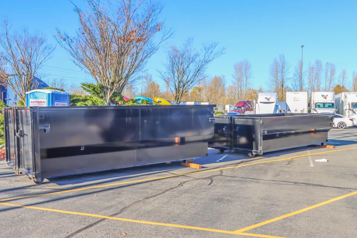 Professional dumpster rental service with roll-off container on residential driveway in Madeira
